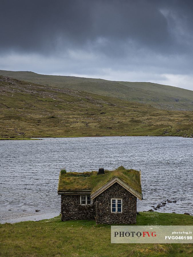 A lonely house in the island of Sandoy, Faeroe islands, Denmark, Europe